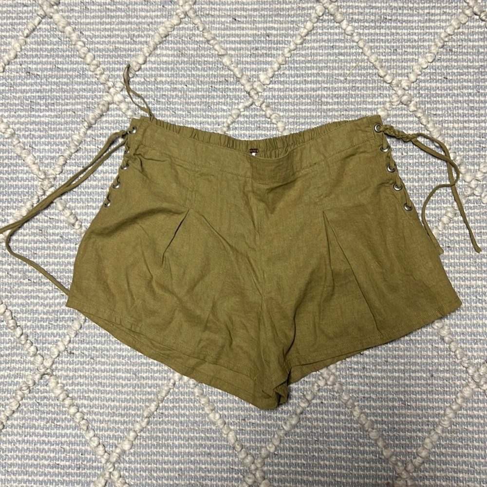 Army green shorts with silver accents on side